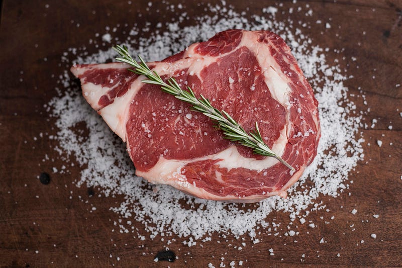 A plate filled with various cuts of red meat