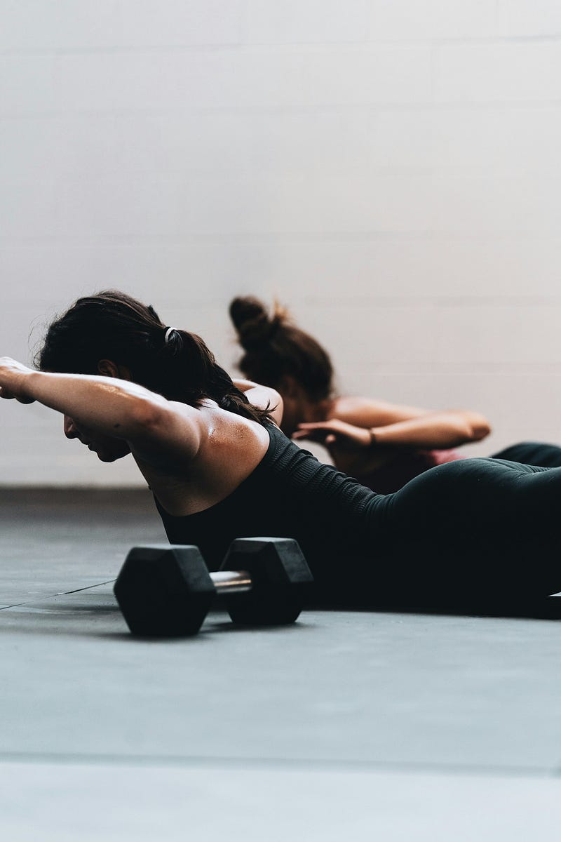 Individual performing prone back extensions