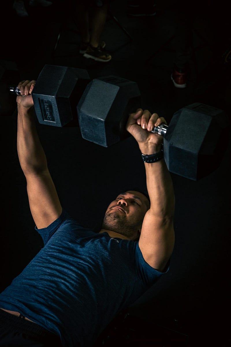 Man performing a dumbbell bench press