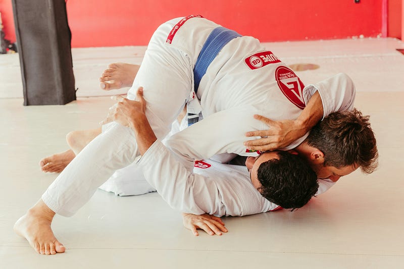 A person training Jiu-Jitsu on the mats